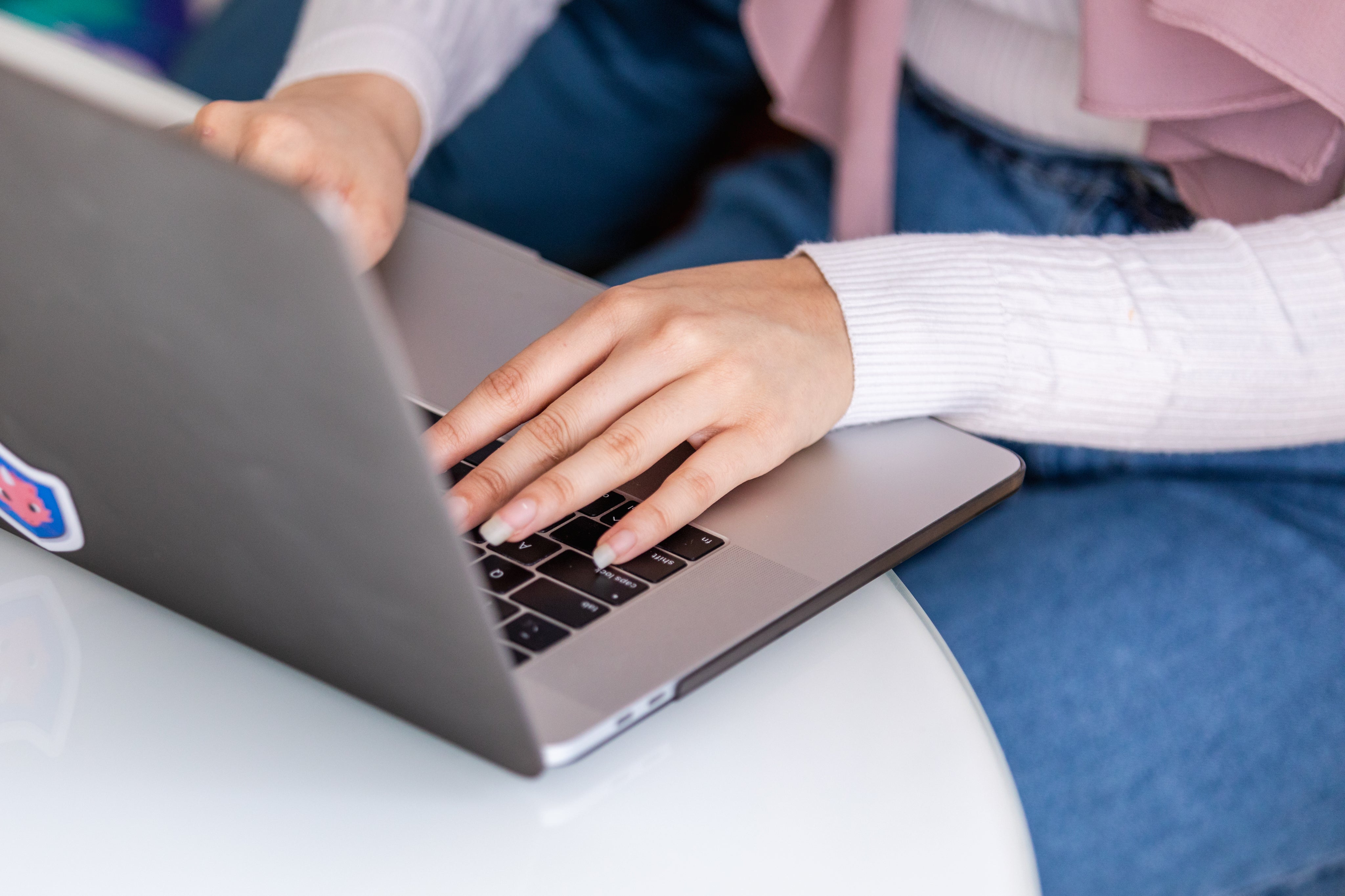 woman-sits-at-table-working-on-laptop.jpg